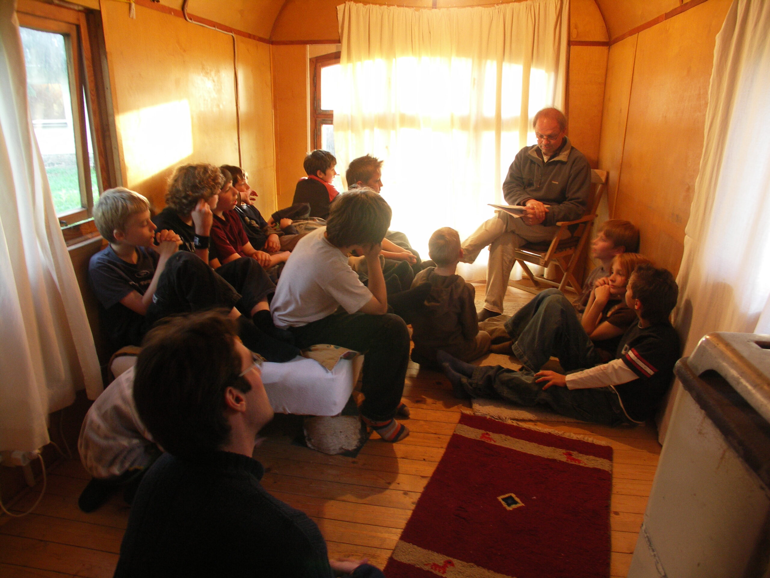 A helper reads a story to the children