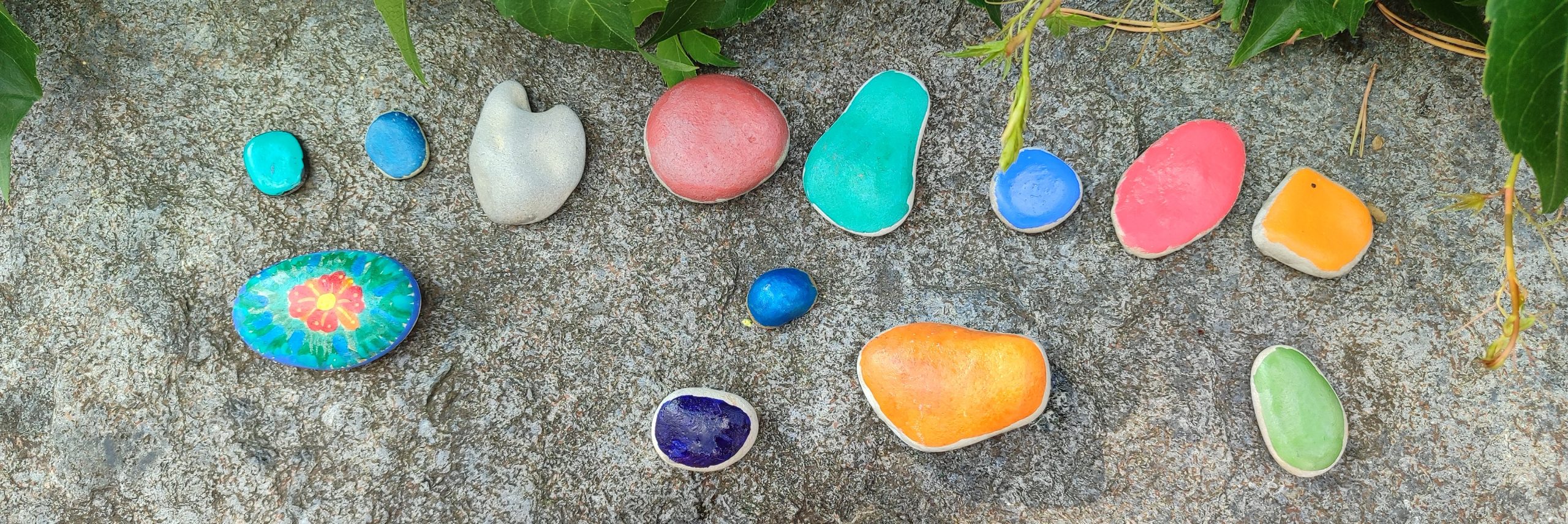 A photo of stones painted by children
